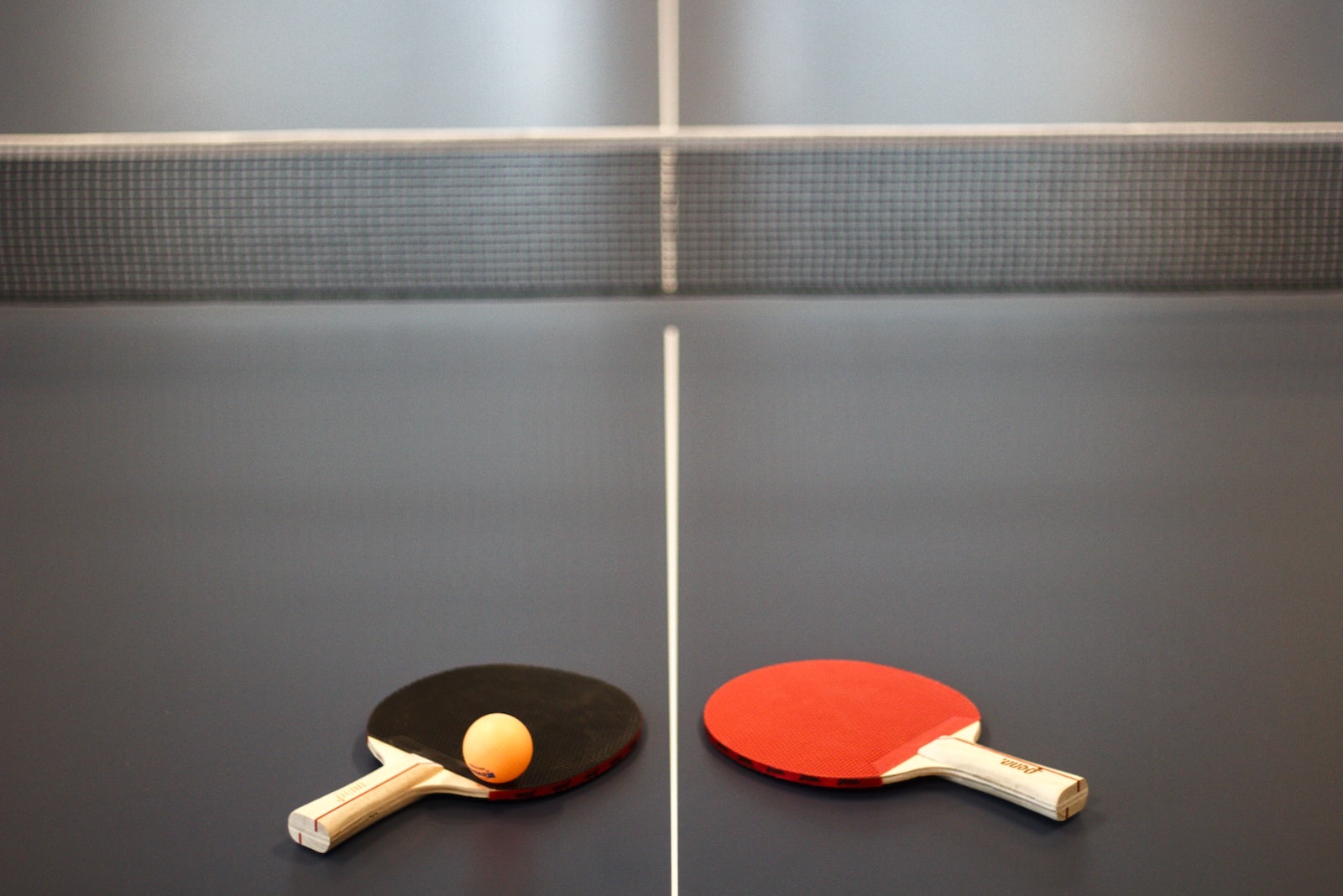 red and brown wooden table tennis racket