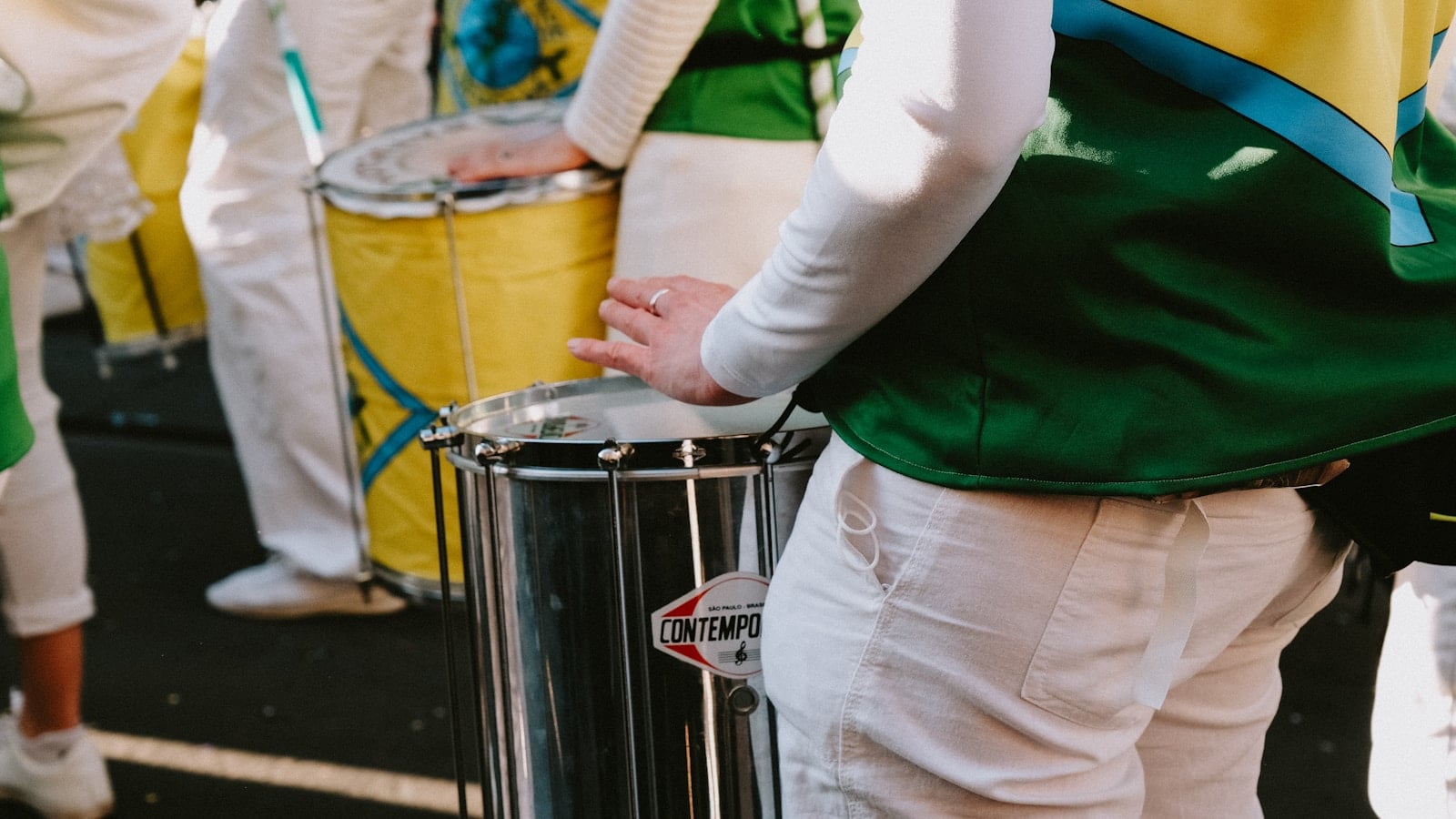 a group of people standing around a drum
